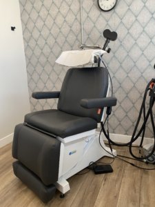 A picture of a TMS chair and TMS magnet. Is TMS right for me? Non-invasive, no sedation or surgery required