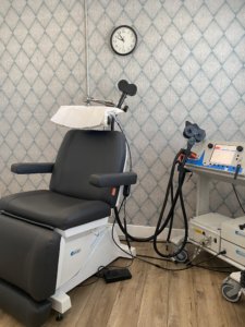 picture of a reclining chair and equipment for transcranial magnetic stimulation (TMS) treatment